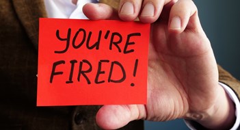 Employer shows phrase You are fired. Wrongful Dismissal concept.